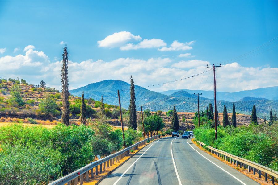 Automatic and manual rental cars parked on a scenic road in Cyprus